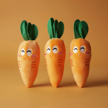 Three plush carrot dog toys, studio photo